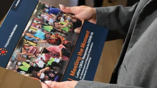 IMG_0111 HF Director of Grants holding a report Hispanic Federation issued mid 2024.