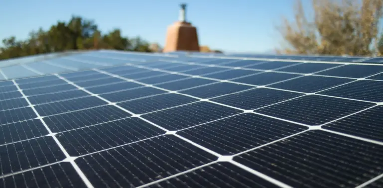 Close shot of a solar panel installation on a rooftop, in horizontal format