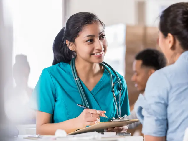 Attentive young doctor talks with female patient Attentive young doctor talks with female patient
